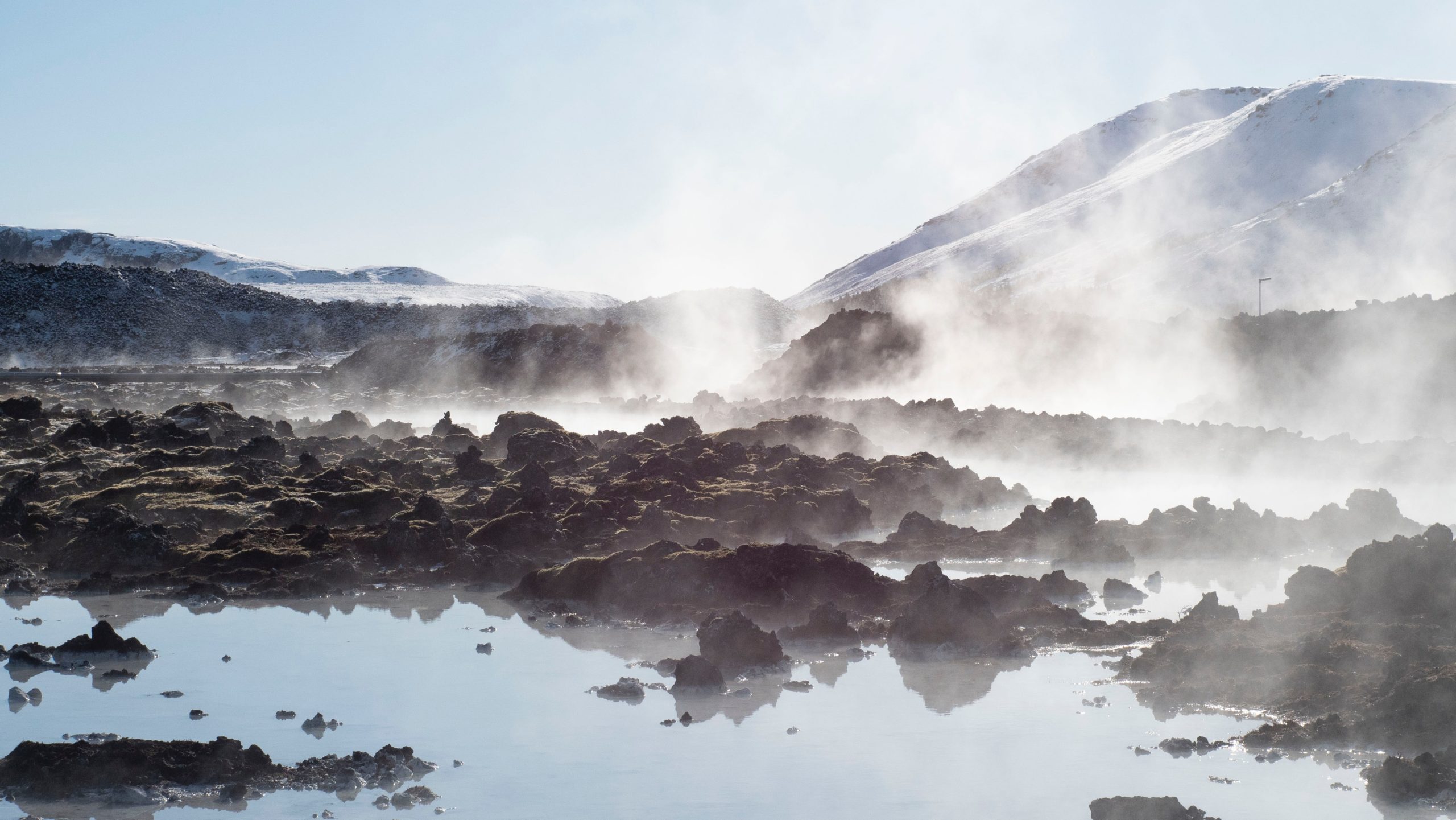 Geothermal steam rising over Iceland's volcanic landscape