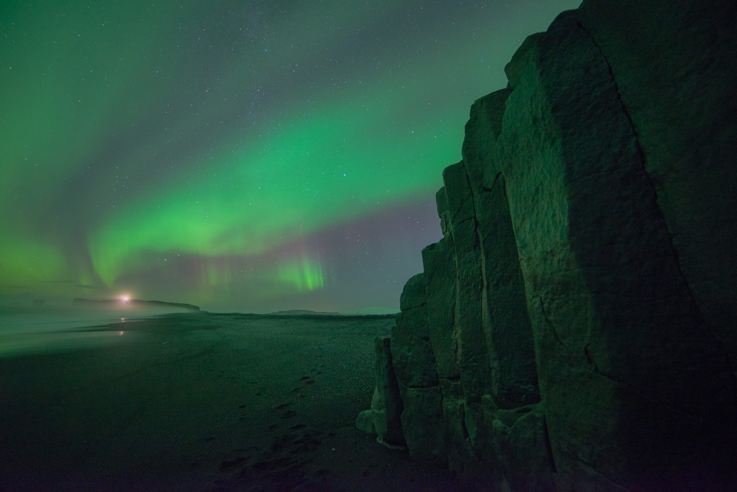 Northern Lights over Reynisfjara black sand beach in Iceland