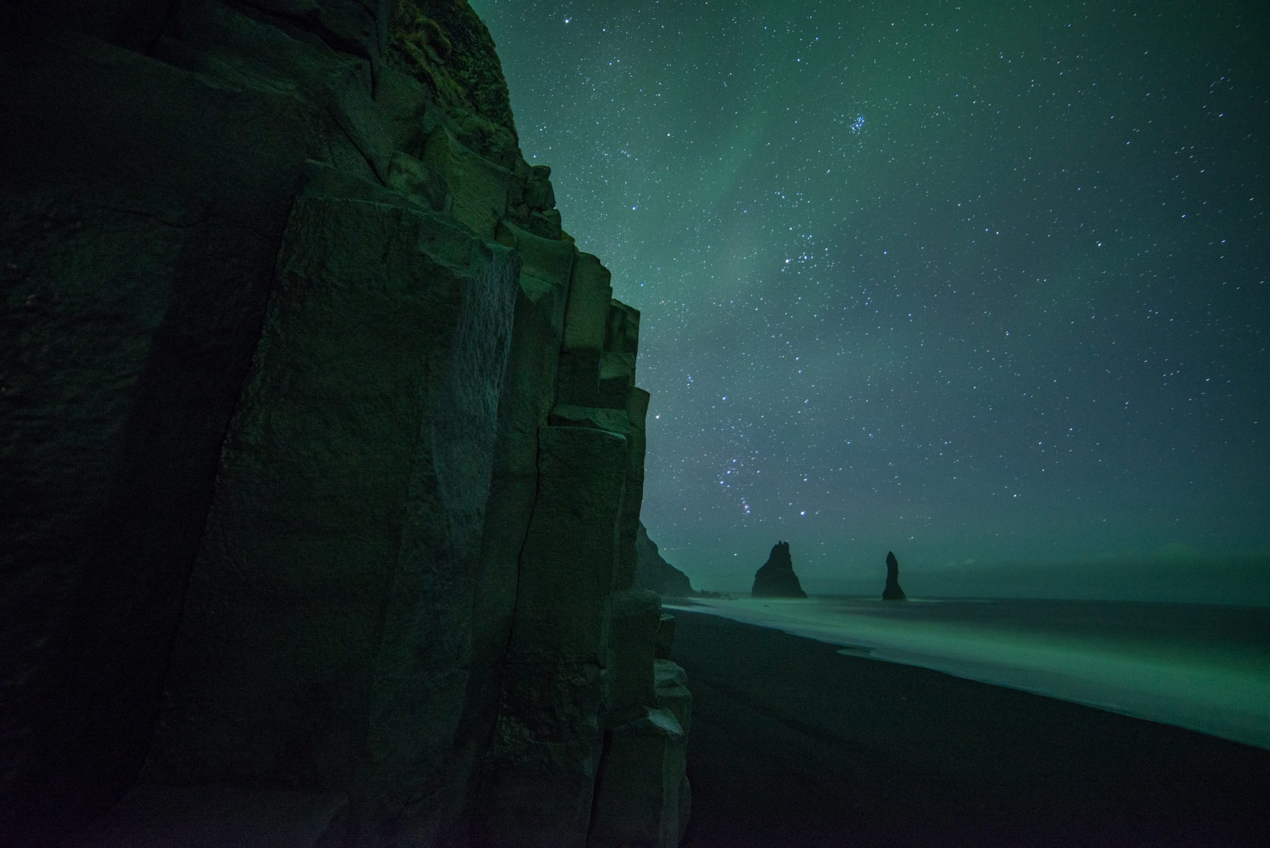 Northern Lights dance over Reynisfjara beach in Iceland