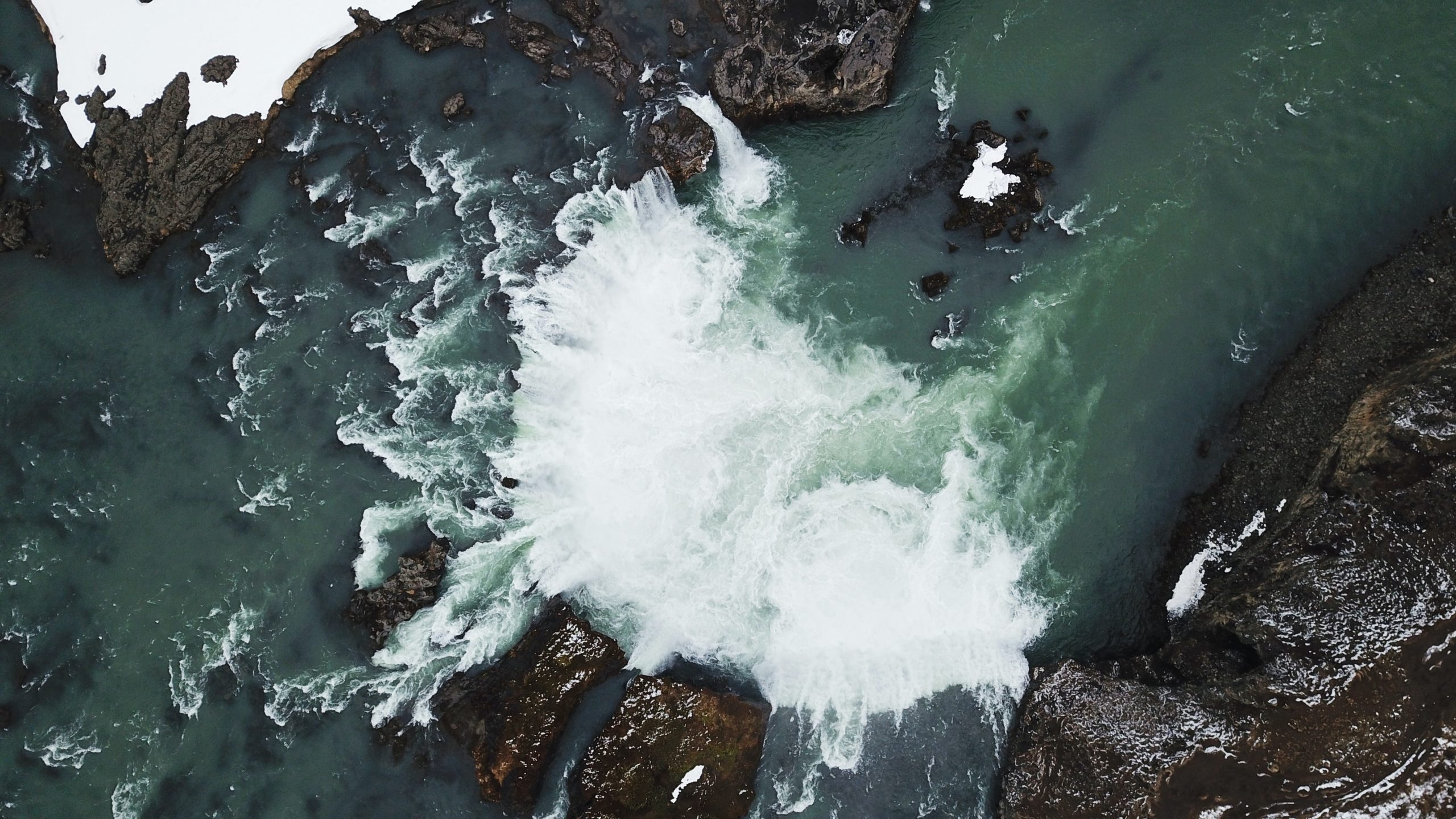 An aerial shot of a waterfall in Iceland