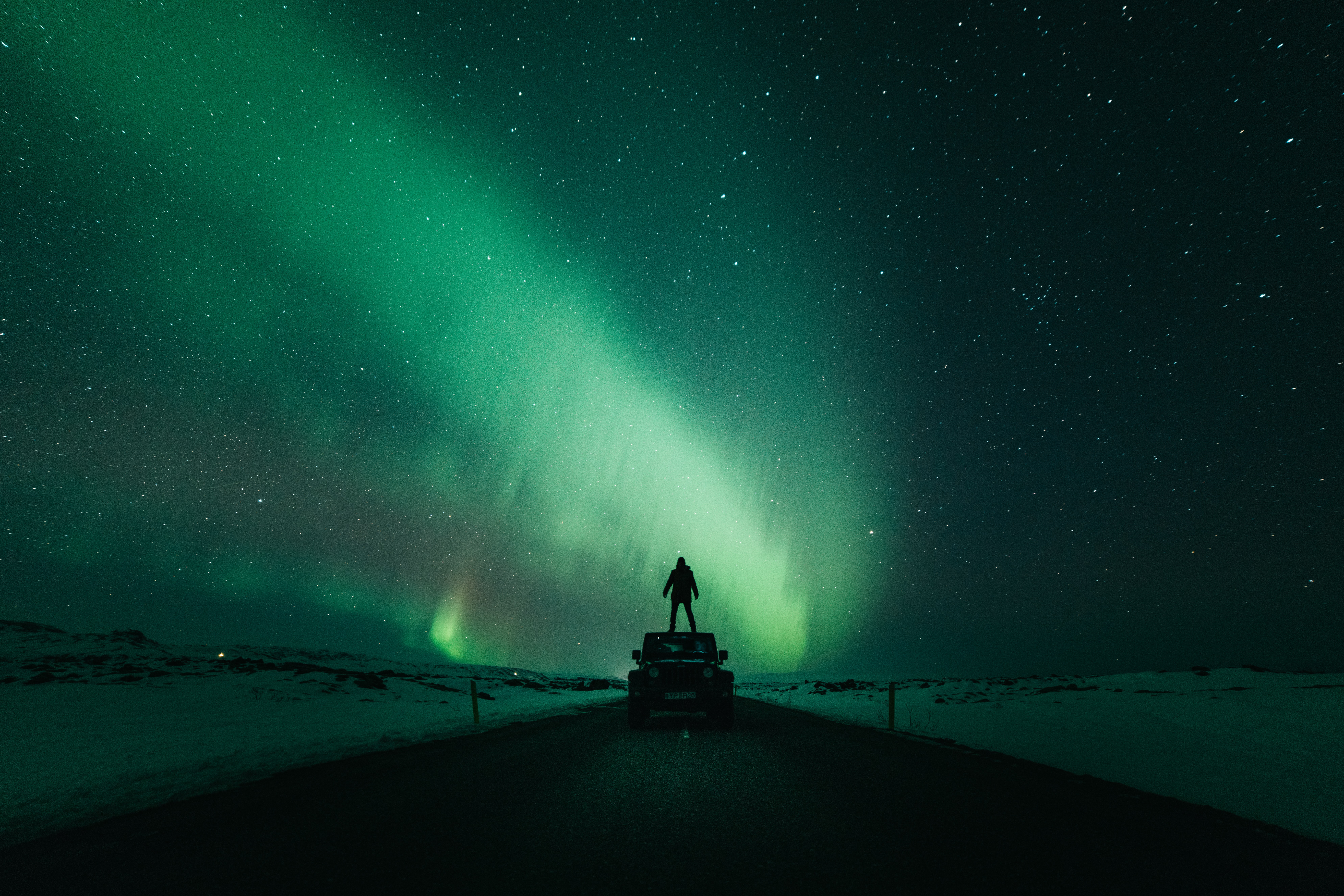 A man looks at the Northern Lights in Iceland