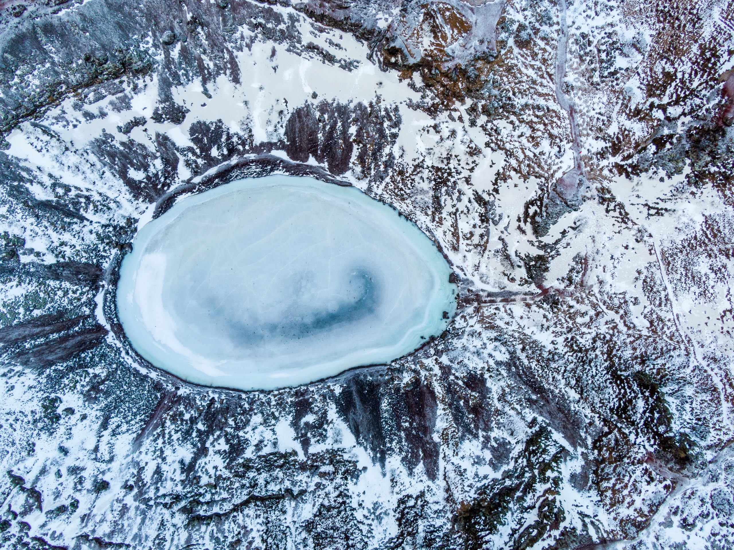 Kerid crater lake frozen in winter.