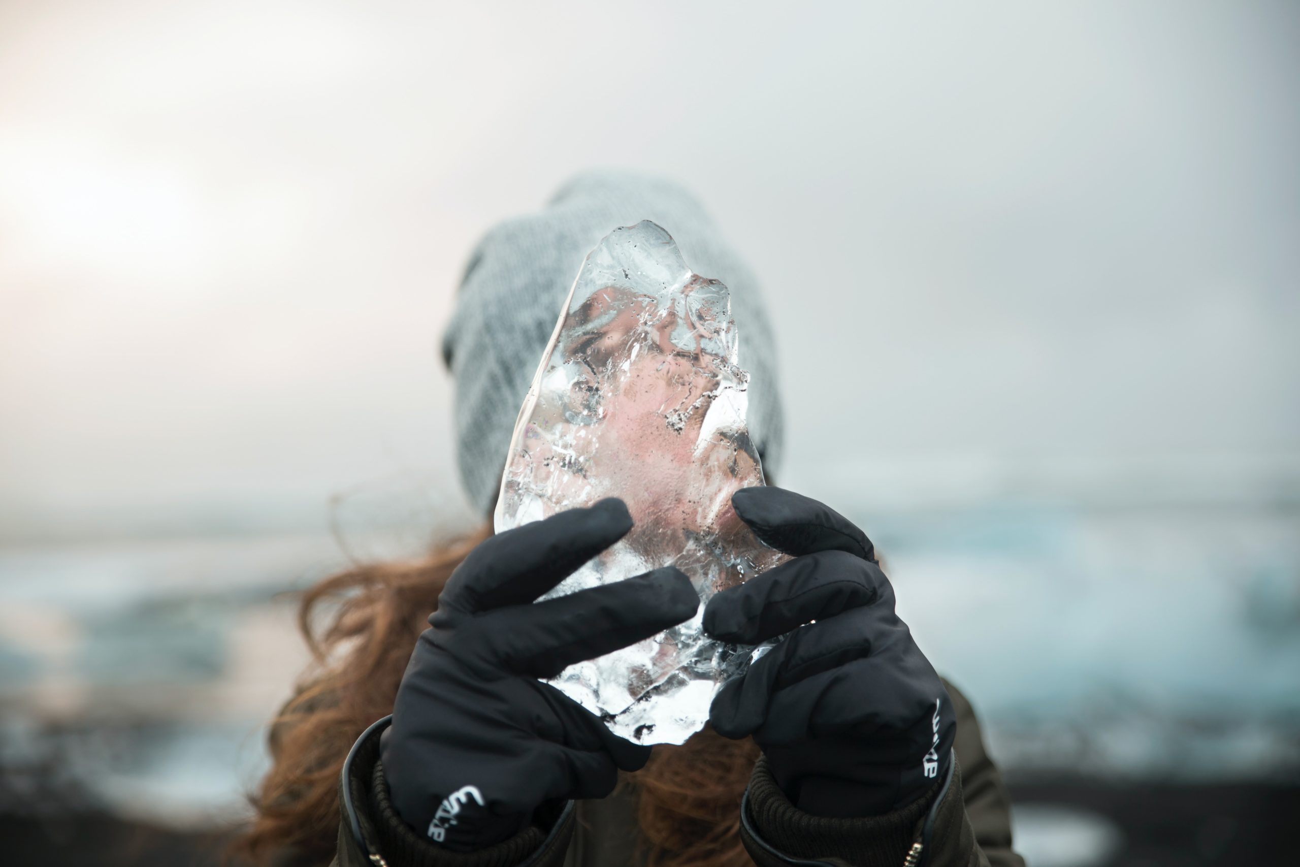 A woman holds ice at Diamond Beach