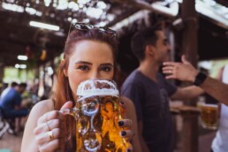 Woman drinking beer outside